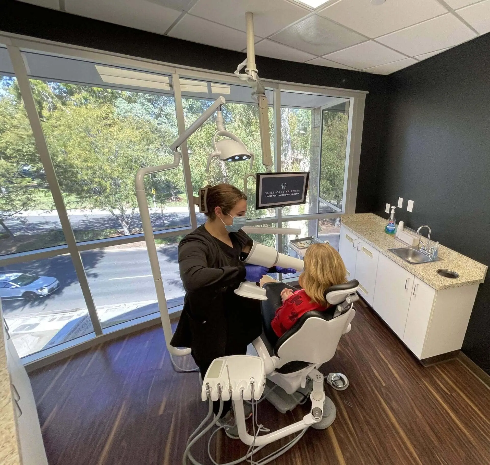 Treatment room with a window view and modern dental chair